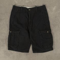 Men's Vintage Levi's Cargo Shorts  + Closure: Zip  + Colour: Black  + Size Label States: Missing  + Actual measurements (inches): W30  + Measurements (Inches): Hem = 10, Rise = 10  Please note that all vintage items have been previously worn, and may show some signs of previous wear. However, any significant damage will be photographed and/or stated in the items listing. Please note that damage to the inside may not always be photographed or listed. Black Casual Cargo Pants With Built-in Shorts, Black Utility Shorts With Hip Pockets, Black Cargo Shorts With Pockets, Black Relaxed Fit Utility Cargo Shorts, Black Cargo Pants With Belt Loops, Black Cargo Shorts With Hip Pockets, Black Cargo Shorts With Belt Loops, Black Short Length Cargo Pants With Belt Loops, Black Short-length Cargo Pants With Belt Loops