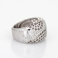 Stylish vintage Cariter ''Nouvelle Vague'' diamond ring crafted in 18 karat white gold (circa 2000).   Round brilliant cut diamonds total an estimated 0.35 carats (estimated at F-G colour and VVS2 clarity).    The out of production Cartier highlights an openwork lattice design with a low dome, sprinkled with diamonds. The ring rises 5mm from the finger (0.19 inches). The ring is great worn alone or stacked with your fine jewellery from any era.   The ring is in very good condition. We have not c Cartier Rings With Diamond Accents, Cartier Diamond Ring With Accents For Gift, Cartier Platinum Diamond Ring With Prong Setting, Luxury Cartier Rings In Diamond White, Formal White Diamond Dome Ring, Cartier Fine Jewelry Diamond Ring, Cartier Brilliant Cut Diamond Ring, Cartier Diamond White Diamond Rings, White Diamond Dome Ring For Formal Occasions