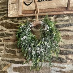 a christmas wreath hanging on a stone wall