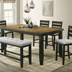 a dining room table with four chairs and a bench