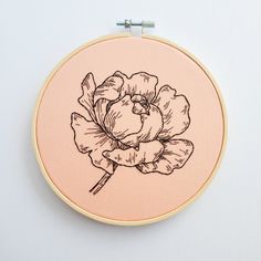 an embroidery project with a flower drawn on it