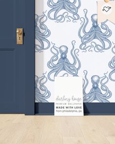 an octopus themed wallpaper in a room with blue door and wooden flooring next to it