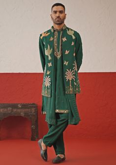 Elevate your style with Green Embroidered Kurta Set With Jacket. Made from luxurious georgette, this set exudes elegance. The jacket showcases intricate resham and sequinned embroidery, while the kurta features meticulous detailing and all-over motifs. Completed with a beautifully embroidered dupatta and matching pants. Perfect for Sangeet, Mehendi, or as a wedding guest outfit. Composition : Jacket, Kurta, Trouser & Dupatta : Viscose Georgette Care: Dry Clean Only and Vacuum Storage This produc Green Kurta With Jacket For Men, Festive Embroidered Green Bandhgala, Festive Green Nehru Jacket With Intricate Embroidery, Designer Embroidered Green Nehru Jacket, Green Nehru Jacket With Intricate Embroidery, Sangeet Outfit For Men, Mehendi Outfit, Sangeet Outfit, Vacuum Storage