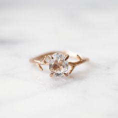 Our dainty Crystal Quartz Ring is part of our new Birthstone Ring Collection! This beautiful, yet delicate ring is made with top-quality, genuine, colorless Clear Crystal Quartz. The April Birthstone represents purity + healing. Not to mention, the unique look of the whimsical vine ring setting will ensure endless compliments. If you're looking for a ring with style, quality and true meaning, look no further. ---------------------- FEATURES ◊ Oval shaped, brilliant cut faceted genuine Clear Crys Delicate Crystal Ring With Rose Cut Diamonds For Gift, Delicate White Topaz Rings For Gift, Nature-inspired Rings With Rose Cut Diamonds For Gift, Nature-inspired Rings With Rose Cut Diamonds As Gift, Nature-inspired Rings With Rose Cut Diamonds, Nature-inspired Rose Cut Diamond Rings For Gift, Clear Quartz Ring, April Birthstone Ring, April Birthday