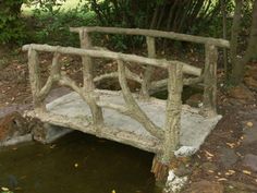 an old wooden bridge over a small pond