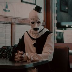 a person wearing a mask sitting at a table