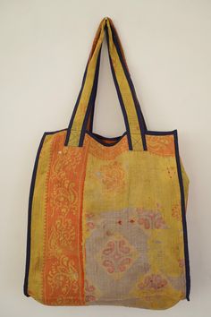 This bag is made from a vintage hand-stitched Kantha quilt. We make only 1-2 bags from each quilt and every one of them is one of a kind! Details: Shell fabric- Vintage Quilted Cotton Kantha 1. width (cm) - 40 2. height (cm)- 45 3. depth (cm) - 45 4. weight (g)- 0.400 kg 5. length of the shoulder (cm) -40 cm Care instructions: Dry clean or Hand-wash in warm water. Drip dry. How it's made: Kantha quilts are made using numerous layers of recycled silk or cotton saris which are hand-stitched in the Vintage Yellow Shoulder Bag For Daily Use, Vintage Yellow Tote Shoulder Bag, Vintage Yellow Shoulder Bag, Vintage Yellow Bag With Removable Pouch, Yellow Vintage Shoulder Bag For Shopping, Quilted Rectangular Satchel For Daily Use, Rectangular Upcycled Bag For Daily Use, Rectangular Upcycled Bags For Daily Use, Vintage Yellow Bag For Daily Use