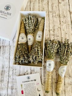 four bundles of dried lavender flowers in a gift box with instructions for making soaps