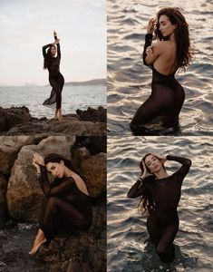 a woman sitting on rocks in the water with her hands up to her face and arms behind her head