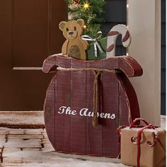 a teddy bear sitting on top of a wooden barrel