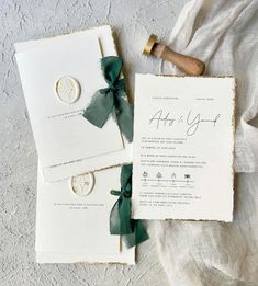 the wedding stationery is laid out on top of each other