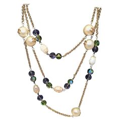 STUNNING Chanel Vintage Gold Necklace with Large Pearls & Green and Purple Crystal Beads in good condition. Gold link chain necklace with large round pearl beads that feature matte gold CC logos and purple and green crystal cut beads. Wear consistent with age and use. Pearl coating is chipping off many of the pearl beads. See photos for details. Light hairline scratches on green and purple beads. This is a rare vintage Chanel piece that is perfect for the Chanel lover who has everything. It can Gold Link Chain Necklace, Vintage Gold Necklace, Chanel Lover, Gold Link Chain, Gold Link, Chanel Vintage, Purple Crystal, Link Chain Necklace, Purple And Green