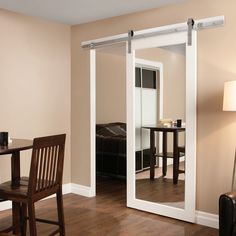 a living room with sliding glass doors leading to a bedroom