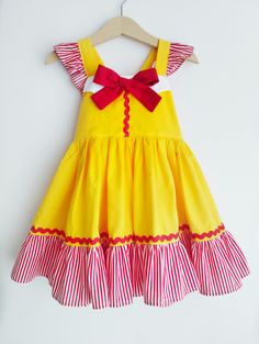 Hand made with love french fries fast food restaurant Cosette dress featuring flutters straps that ties into a bow at the back. Stretchable back, full twirly ruffled skirt. Perfect for themed birthday parties and photoshoot. or just as an outfit for a trip to her favourite french fries place for a meal. Handmade to order from size 1t to 8t. Please refer to the sizing chart provided for the size references. Care instructions: Handwash cold with mild soapy water and hang dry. Iron on light settings. Due to the handmade nature of this product, we do not accept returns or refunds unless there is a manufacturing error by us. Thank you for viewing our listing, have a great day! Cute Ruffled Sundress For Party, Red Ruffled Dresses For Playtime, Fun Ruffled Dresses For Birthday, Fun Ruffle Dress For Birthday, Fun Ruffled Dresses For Birthdays, Fitted Ruffle Sundress For Dress-up, Fitted Ruffle Sundress For Dress-up Events, Fitted Ruffle Sundress For Dress-up Occasions, Fun Fitted Ruffle Dresses