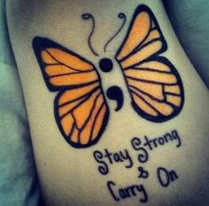 a woman's stomach with a butterfly tattoo on it that says stay strong and carry on