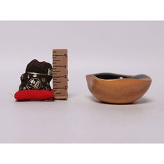 a wooden bowl with a measuring tape next to it