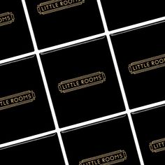 black and gold business cards with the words little rooms written in gold on each card