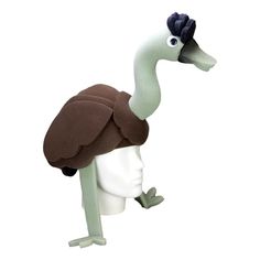 an ostrich wearing a brown hat and green leggings is standing on a white mannequin's head