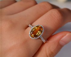 Gorgeous 8*12 mm oval Citrine ring, made with 925 sterling silver, plated with white gold. Main Stone: 8*12 mm Natural Citrine Side Stone: CZ Need other size please contact. CS0100 Yellow Oval Topaz Ring With Halo Setting, Yellow Oval Halo Jewelry, Yellow Oval Topaz Rings, Fine Jewelry Yellow Oval Topaz Ring, Oval Citrine Topaz Ring In White Gold, Oval Citrine Ring With Prong Setting, Yellow Oval Topaz Ring With Center Stone, Oval Citrine Rings With Prong Setting, Oval Orange Topaz Gemstone Ring