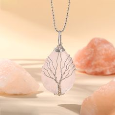 PLEASE NOTE: Our crystal stones are natural minerals and each crystal is unique. The internal ice cracks, pits, mineral points, and color differences of natural crystals are all formed naturally and are normal phenomena, which will not affect the efficacy, beauty and value of the crystal at all.This necklace is probably the most beautiful piece of jewelry you'll ever see. The intricate tree design weaved around the gorgeous rose quartz adds to this necklace's charm. Rose quartz, a crystal of unc Raw Quartz Stone Pendant Necklace, Raw Stone Crystal Pendant Necklace Gift, Gift Crystal Pendant Necklace With Raw Stone, Silver Nature-inspired Crystal Necklace For Healing, Rose Quartz Gemstone Pendant Necklace, Nature-inspired Silver Crystal Necklace For Healing, Spiritual Teardrop Pendant Crystal Necklaces With Natural Stones, Rose Quartz Crystal Necklace For Healing, White Rose Quartz Crystal Necklace Gift