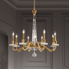 a chandelier with many lights hanging from it's sides in a room