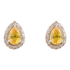 This is part of Chairish’s Fine Jewelry assortment.  Everyday Yellow Sapphire and Diamond Stud Earrings in 18K Gold to make a statement with your look. You shall need stud earrings to make a statement with your look. These earrings create a sparkling, luxurious look featuring pear cut yellow sapphire and round cut diamonds. Sapphire stimulates concentration and reduces stress. Designed with pear cut yellow sapphire in center with halo of diamonds around in solid gold. This is a beautiful handcra Yellow Diamond Accented Fine Earrings, Yellow Diamond Accent Earrings In Fine Jewelry Style, Fine Jewelry Yellow Earrings With Diamond Accents, Yellow Earrings With Diamond Accents In Fine Jewelry Style, Luxury Yellow Teardrop Earrings, Yellow Earrings With 17 Jewels For Formal Occasions, Formal Yellow Earrings With 17 Jewels, Yellow Earrings With Diamond Accents, Fine Jewelry Yellow Earrings For Anniversary