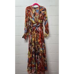 This Is A New With Tags Spy Zone Exchange Long Flowy Maxi Dress In Size S. The Dress Features A Floral Botanical Pattern, V-Neckline, And Long Balloon Sleeves With Elasticated Cuffs. It Has A Pullover And Button Closure, And Is Made Of Chiffon Polyester Material With Ruffle, Frill, And Elasticated Waist Accents. The Dress Is Lined And Has A Long Dress Length. It Is Suitable For Travel, Wedding, Party/Cocktail, Formal Occasions, And Has A Nature, Beach, Flower, Wedding, Baby Shower, Bohemian, Pea Long Floral Print Patterned Dress, Printed Floral Dress For Fall Vacation, Multicolor Long Sleeve Floral Dress For Vacation, Orange Floral Print Long Sleeve Maxi Dress, Long Sleeve Multicolor Floral Dress For Vacation, Multicolor Floral Dress For Fall Vacation, Orange Long Sleeve Printed Maxi Dress, Multicolor Long Sleeve Dresses With Vintage Print, Multicolor Long Sleeve Dress With Vintage Print