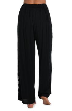 These palazzo pants get their boho-inspired style from crocheted side panels. Perfect for pulling on post dip, you can wear them as a swimsuit cover-up but they also look fabulous with a tank or cami for an effortlessly chic look. A gently elasticized waist offers a comfortable fit. [split] Details Palazzo-style beach pants Elasticized waistband Wide legs for a flowy fit Lightweight rayon fabric Fabric 100% Rayon Wide Leg Pants With Lace Trim For Night Out, Casual Party Bottoms With Lace Trim, Chic Black Pants With Lace Trim, Pallazo Pant, Coastal Crochet, Crochet Panels, Black Palazzo Pants, Palazzo Style, Palazzo Pant