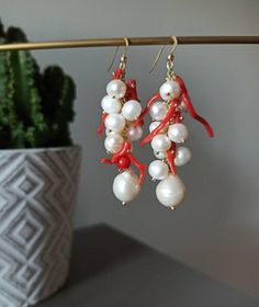 Handmade cluster earrings made with Freshwater Pearls, white color, and Red Coral branches. GOLD PLATED 925 STERLING SILVER Lenght : 5 cm / 1,97 inches * SHIPPING * Your order will be shipped within 1-3 business days from your purchase. You can choose between 2 shipping methods: STANDARD MAIL (NOT TRACEABLE) It is a cheap and fast shipping method, but NOT TRACEABLE. Chapeau Atelier is not responsible for any postal disruptions, delays or losses. REGISTERED MAIL (TRACEABLE) It is an absolutely sa Coral Earrings With Ear Wire As Gift, Handmade White Dangle Cluster Earrings, Handmade Coral Earrings For Gifts, White Pierced Cluster Earrings As Gift, Handmade Coral Earrings For Wedding, River Pearls, Natural Coral, Coral Jewelry, Chip Beads