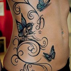 a woman's back with butterflies and swirls on her stomach, which is decorated with