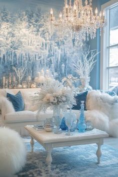 a living room filled with white furniture and a chandelier hanging from the ceiling