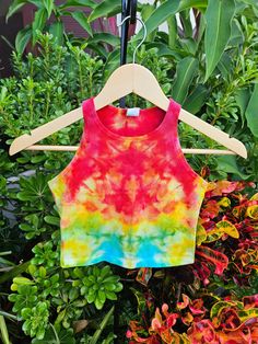 Hand Dyed- This one of a kind psychedelic rainbow crop top has been hand-dyed in beautiful Sarasota, Fl with red, yellow, blue and green colors. These boho tie dye x small crop tops are a unique retro outfit to wear to a concert or hippie festival. They are great to wear to yoga, pilates, and the gym. Support eco friendly made in USA clothing! Feel good knowing that you are making a difference by purchasing fair trade ethical fashion. Perfect gift for a teen girl who wears junior's clothing or a student at university or college.  Dyes- High-quality procion dyes from Dharma Trading Company. Top- 92% Cotton, 8% Elastane. Very soft mid weight cotton. Slight Stretch. Sourced from Dharma Trading. Made in the U.S.A.  Sizing- X Small (Women's) or Medium (Juniors) - Length 13 inches Width 13.5 inc Rainbow Crop Top, Yoga Festival, Retro Outfit, Boho Tie Dye, Eco Packaging, Usa Clothing, Tie Dye Crop Top, Tie Dye Tank Top, Usa Outfit