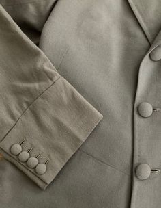 "Well tailored double breasted wool coat by Morty Sills has covered buttons in the front, on the cuffs and in the back. Coat is lined in a taupe satin and has two inside pockets, slight shoulder pads and a back kickpleat. In excellent vintage condition The Morty Sills brand has been referred to as \"the tailor to the CEO\". Morty Sills specialized in high-end formal/semi-formal wear for men and women. Handcrafted in the USA. Shoulders 17\" Chest 40\" Waist 36\" Hips 42\" Length from back of neck Elegant Single Breasted Khaki Outerwear, Elegant Single-breasted Khaki Outerwear, Elegant Khaki Outerwear With Lapel Collar, Semi-formal Solid Blazer With Buttons, Solid Semi-formal Blazer With Buttons, Fall Beige Suits With Buttons, Solid Blazer With Buttons For Semi-formal Occasions, Beige Fall Suits, Classic Gray Outerwear With Button Cuffs