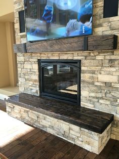 a fireplace with a flat screen tv mounted on it's wall above the mantle