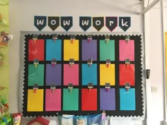 a bulletin board with colorful sticky notes attached to it's sides and hanging on the wall