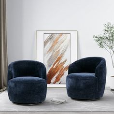 two blue chairs sitting next to each other on a white rug in front of a painting