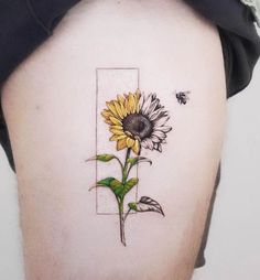 a sunflower tattoo on the back of a man's thigh