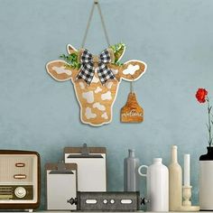 a clock with a cow head hanging from it's side next to other items