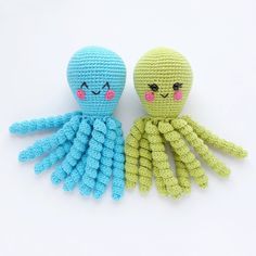 two crocheted octopus dolls sitting next to each other