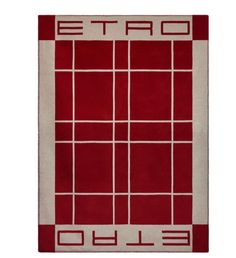 a red and white rug with the words etro in squares on top of it