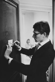 a man in a suit is opening the door