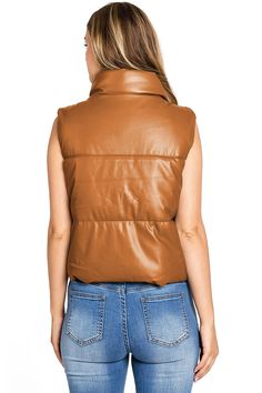 Classic puffer vest with a buttery, soft faux-leather look. Stand collar neckline with a zipper and button closure and pockets on the sides. CARE | Do NOT Wash/ Spot Clean Only CONTENTS | Self: 100% Polyurethane; Lining/Filling: 100% Polyester MEASUREMENTS | 20"/51 cm Top to Bottom (Size Small) MODEL | 5'8 - wearing a size Small IMPORTED Faux Leather Vest, Leather Vest, Puffer Vest, Tube Top, Dark Black, Stand Collar, Puffer, Faux Leather, Leather