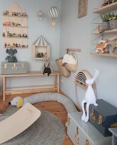 a child's room with toys and decor on the walls, including stuffed animals