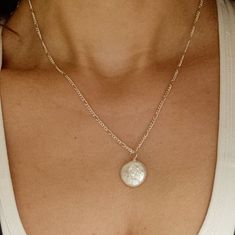 Pearls are timeless, and this flat freshwater coin pearl is no exception! Hung solitaire on a 925-sterling silver chain, it's easy to wear to the beach or to a wedding. The perfect everyday piece!  This pearl necklace is a handmade item. Due to the natural variation and uniqueness of pearl. All pearl pendants will vary from piece to piece. Please note that there will be a slight difference in size, color, and inclusion within the stone. Measurements: 925 silver chain length: 18 inches/ 45 cm fre Sterling Silver Pearl Charm Necklace, Elegant Silver Round Pendant Coin Necklace, Elegant Sterling Silver Round Disc Coin Necklace, Everyday Sterling Silver Necklace With Pearl Charm, Dainty Pearl Charm Round Necklace, Sterling Silver Medallion Necklace With Pearl Pendant, Silver Pendant Pearl Necklace For Everyday, Elegant Silver Coin Necklace With Adjustable Chain, Pearl Chain Coin Necklace