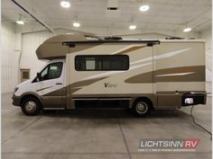 an rv parked in a garage with lights on