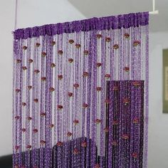 purple beaded curtains hanging from the ceiling