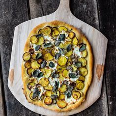 a pizza sitting on top of a wooden cutting board