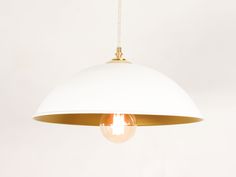 a white and gold light hanging from a ceiling