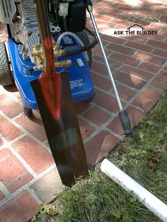 a snowboard leaning against a pole on the sidewalk