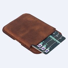 This beautiful FULL GRAIN LEATHER CARD HOLDER WALLET is made of the finest quality genuine leather and is a unique way to store your credit cards, business cards, id cards, or driver's license. It is a great gift for men or women. The wallet can be stick-on/attaches to the back of the phone. You can also choose between different colors and designs. Product Features: Made of full-grain genuine leather. Stick-on/attach to the back of the phone or phone case with its magnetic field property. Availa Brown Rfid Blocking Card Holder For Business, Brown Bifold Wallet With Hidden Phone Sleeve, Brown Card Holder With Id Window, Brown Rfid Blocking Wallet For Personal Use, Classic Brown Card Holder With Phone Sleeve, Brown Business Coin Purse With Card Slots, Classic Brown Card Holder For Personal Use, Brown Business Card Holder With Interior Slots, Brown Business Card Holder With Id Window